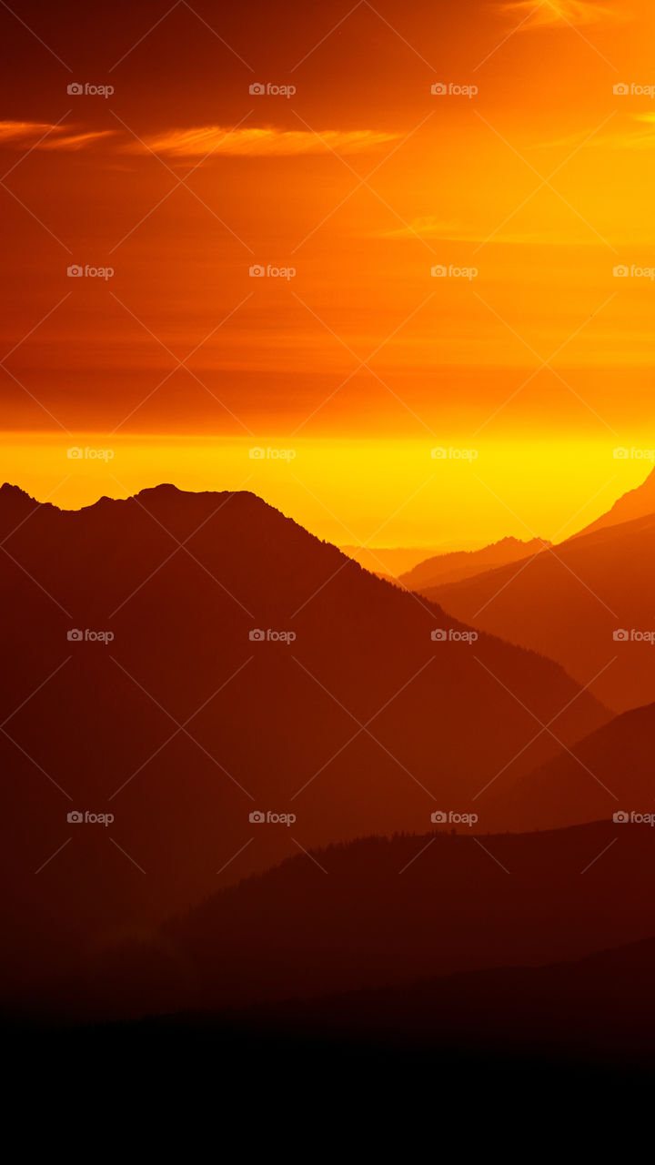 An inspiring red mountain landscape. Tatry mountains in Slovakia. A beautiful wallpaper for smartphone screen. Red abstract gradient with perspective.