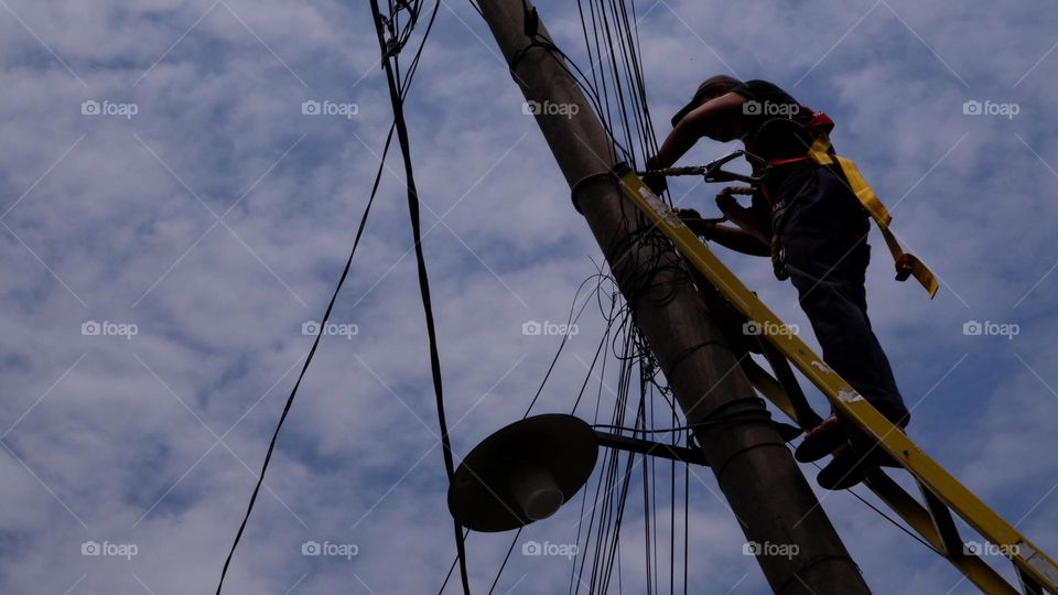 Human interest - A worker is repairing a street light