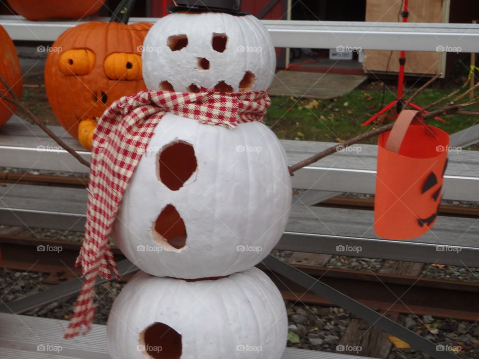 A snowman jack-o’-lantern with scarf