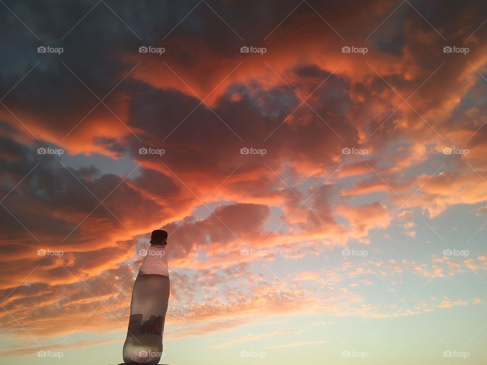 Magic sunset and a beautiful bottle embraces high sky.