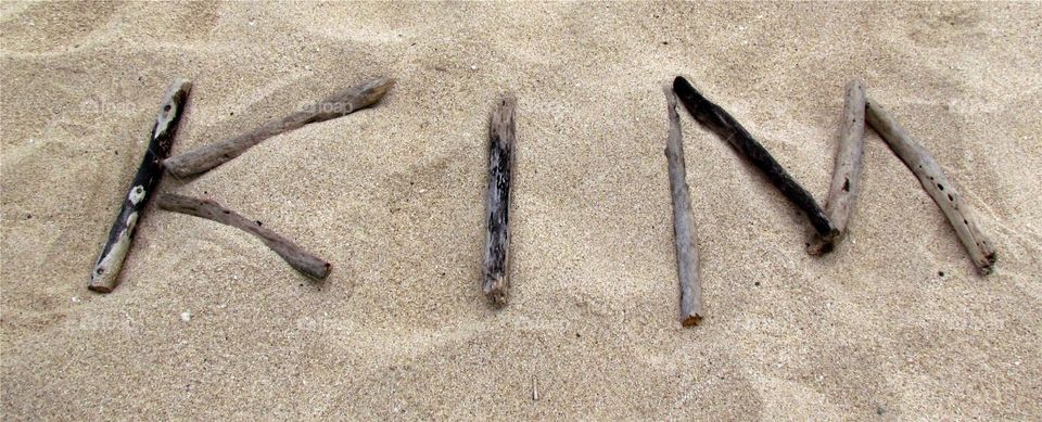 Kim name in the sand. Kim spelled out  with driftwood in the sand in hawaii