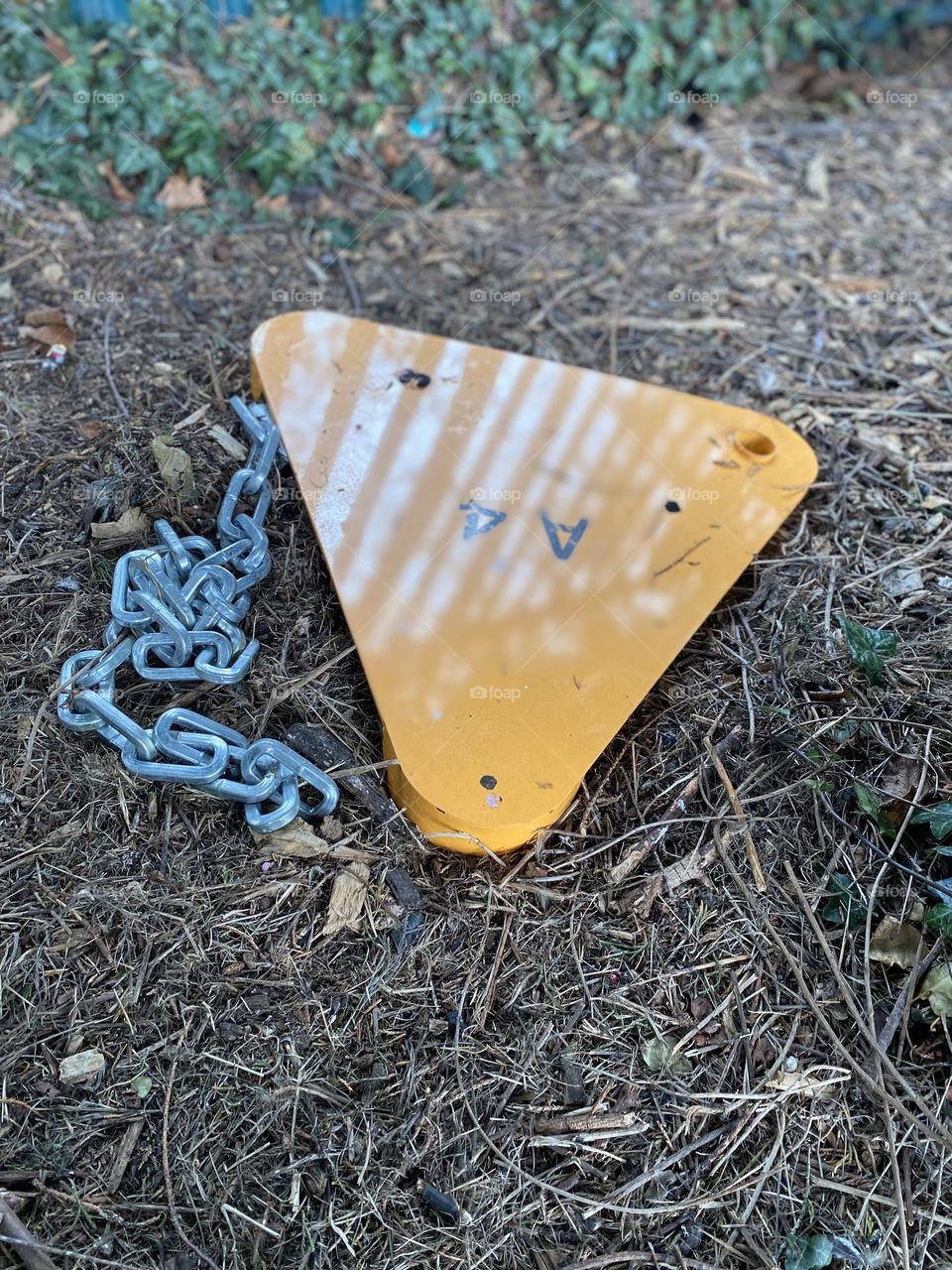 Yellow Triangle warning sign fallen on the ground