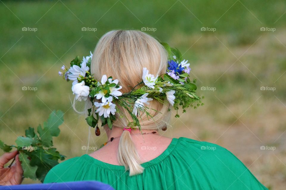 Woman wearing flower crown during solstice featival celebrated by latvians 