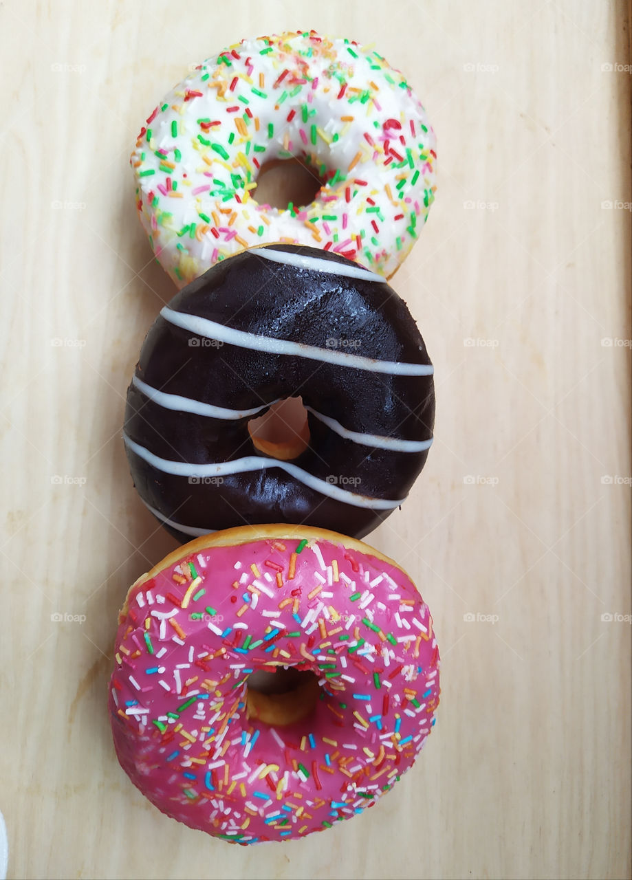 Three multicolored donuts