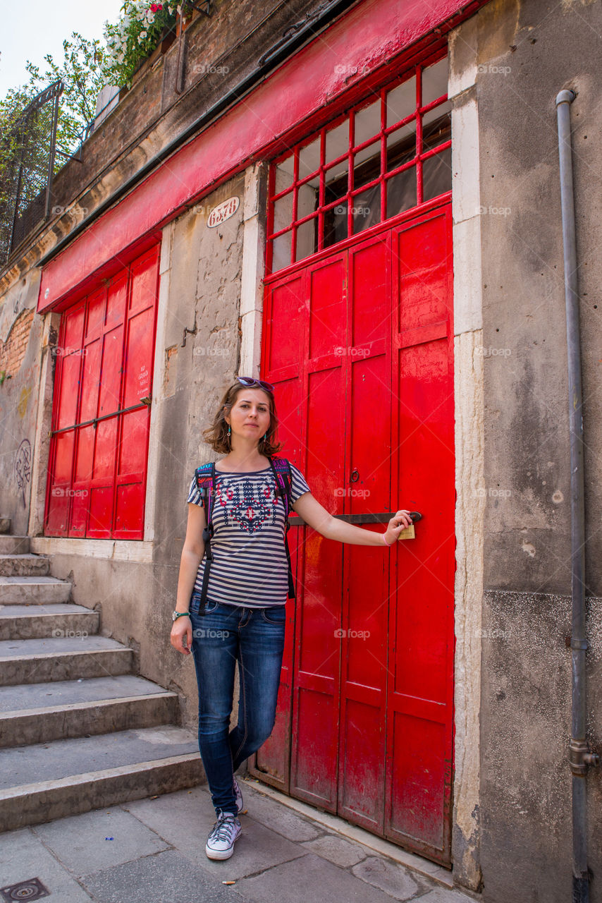 Girl an a red door