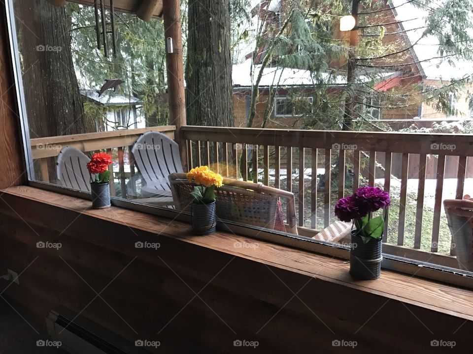 Cozy cabin in the woods, nice vacation home. Wooden  walls and furniture. Colorful flowers