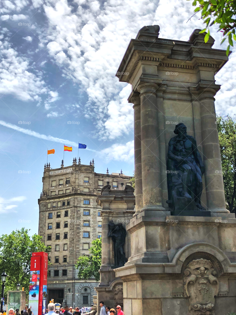 Plaza de Catalunya statues in barcelona with tree flags in the back: Spain, Catalunya and European Union