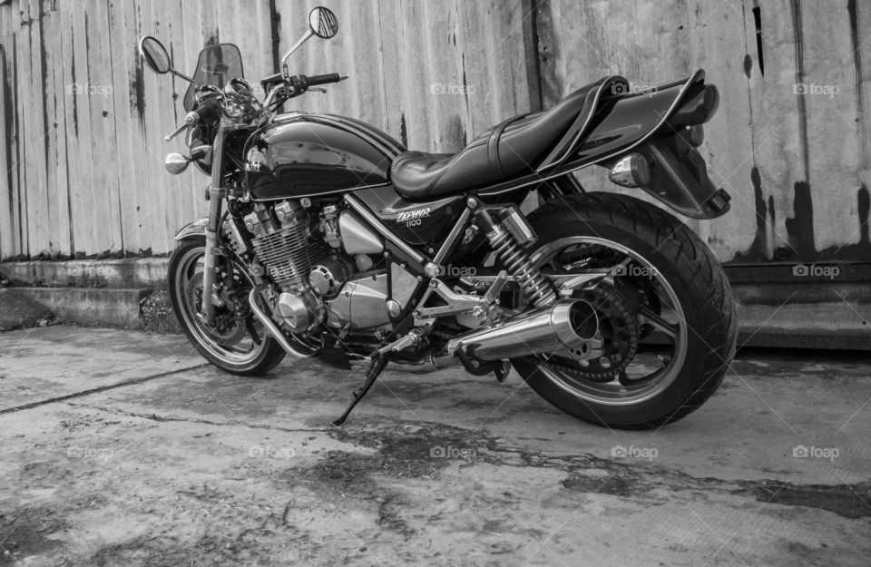 kawasaki zephyr motorcycle in front of the old rusty garage