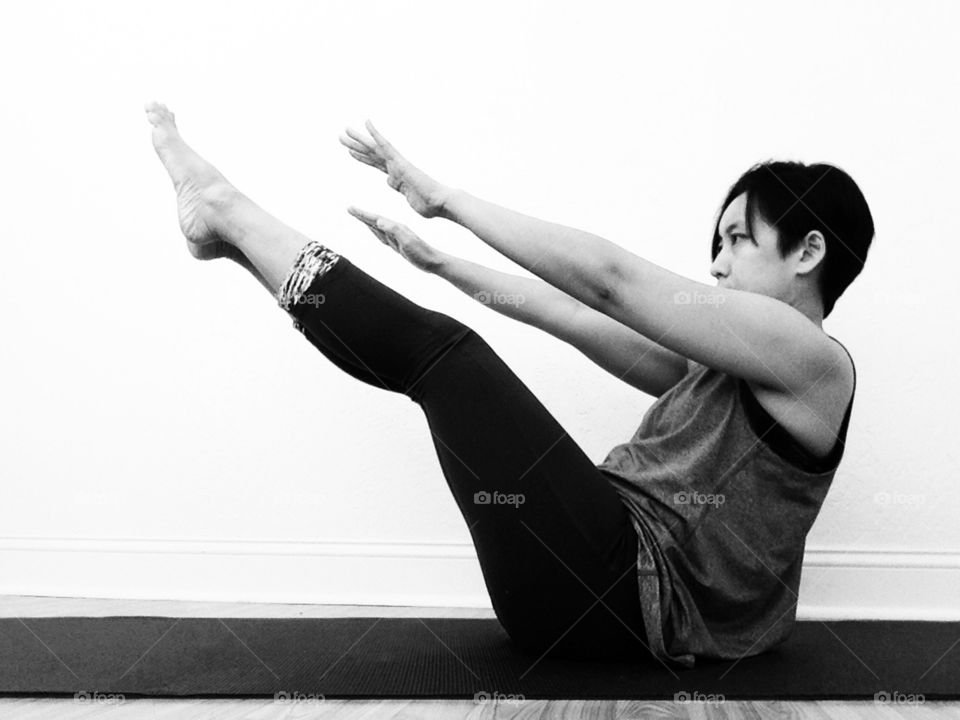 Woman doing yoga on exercise mat