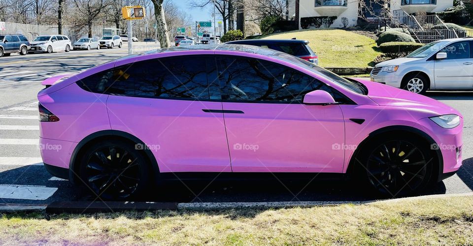 Gloss hot pink Tesla, a sporty sleek set of wheels fit for Barbie. Definitely a dream car. 