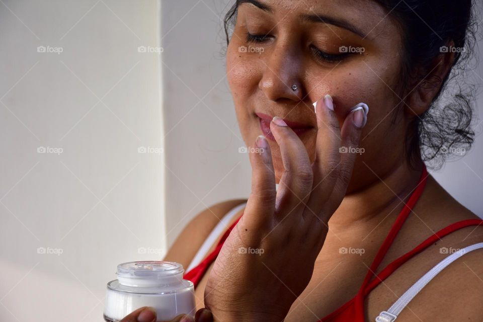 Woman applying cream