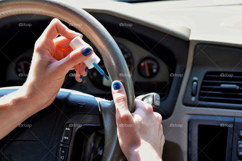 Woman doing nails while driving