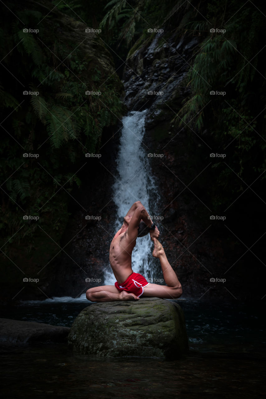 A day at the waterfall, a good friend doing a pose on the rock, freeze and not moving for a second