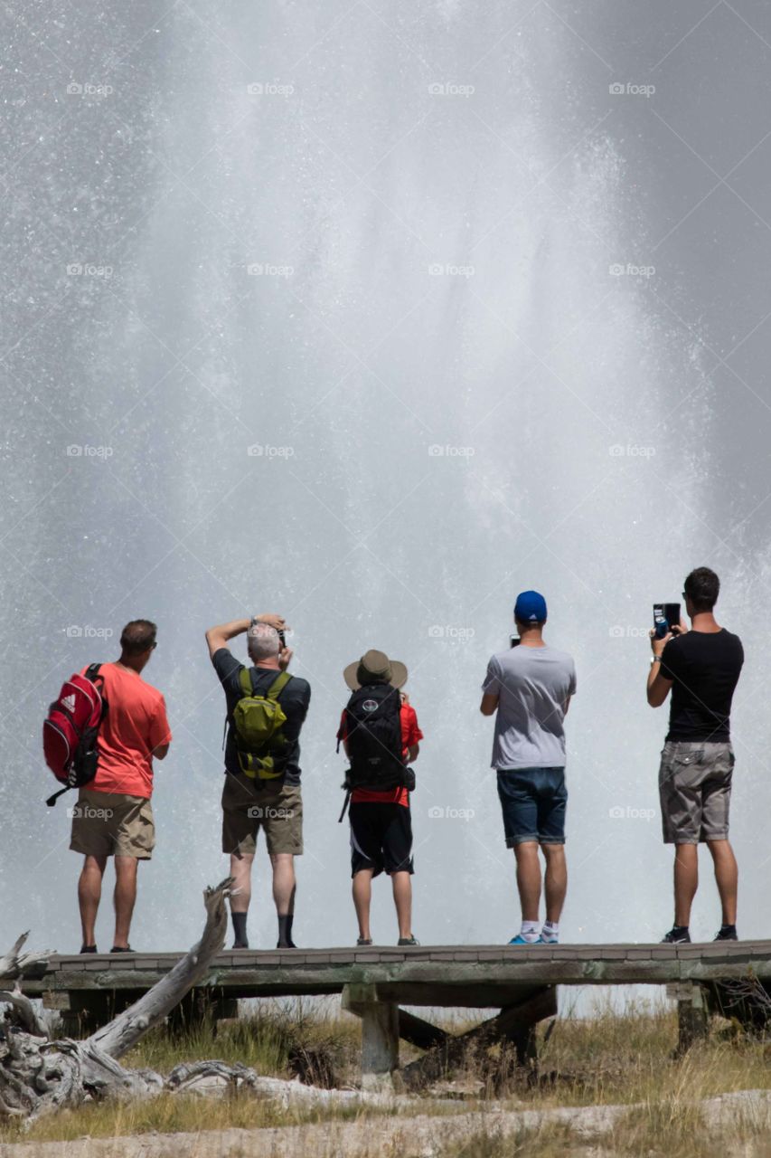 People viewing a geyser erruption