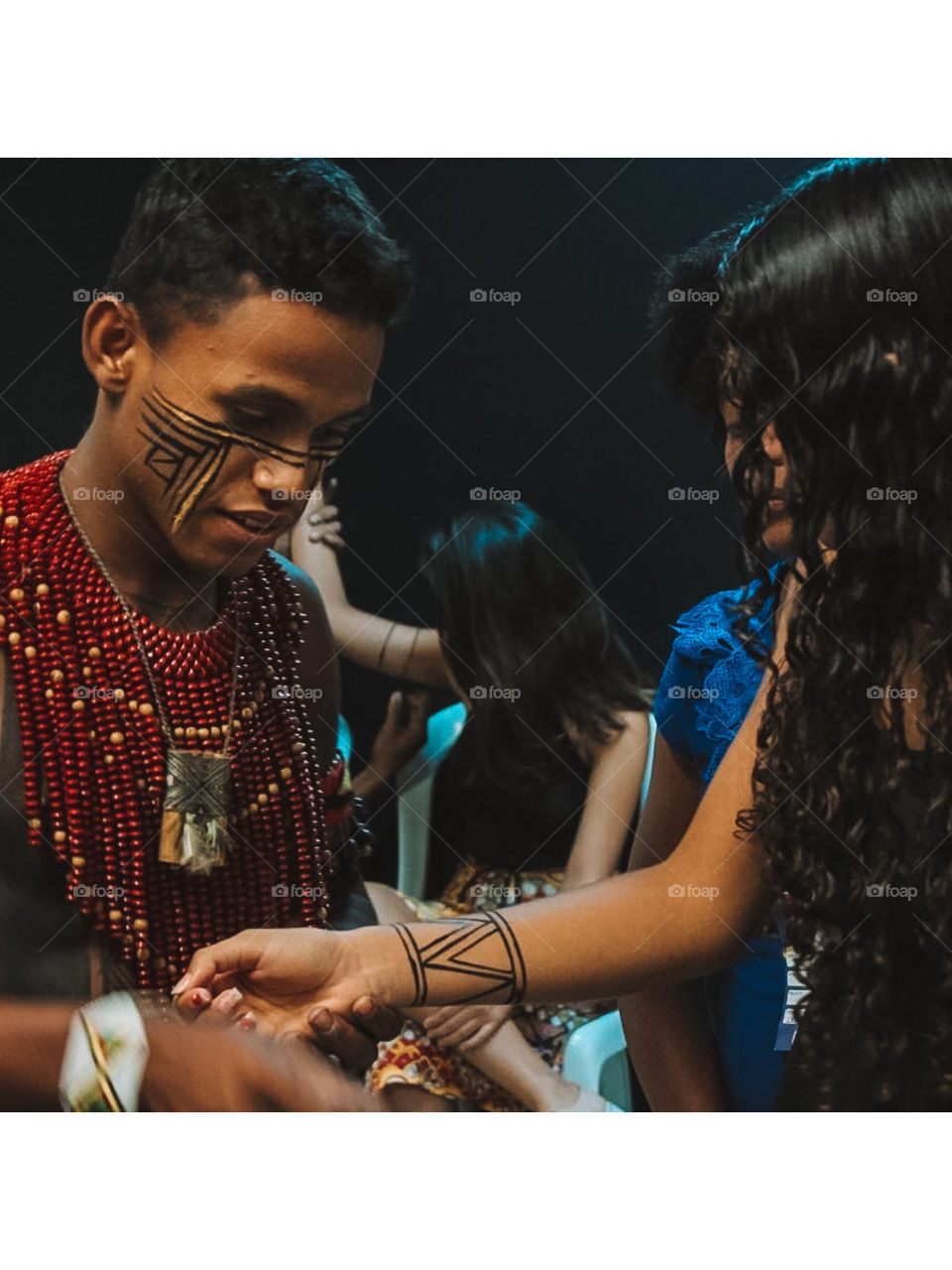 Indigenous young man painting his Pataxó people who live in the extreme south of Bahia