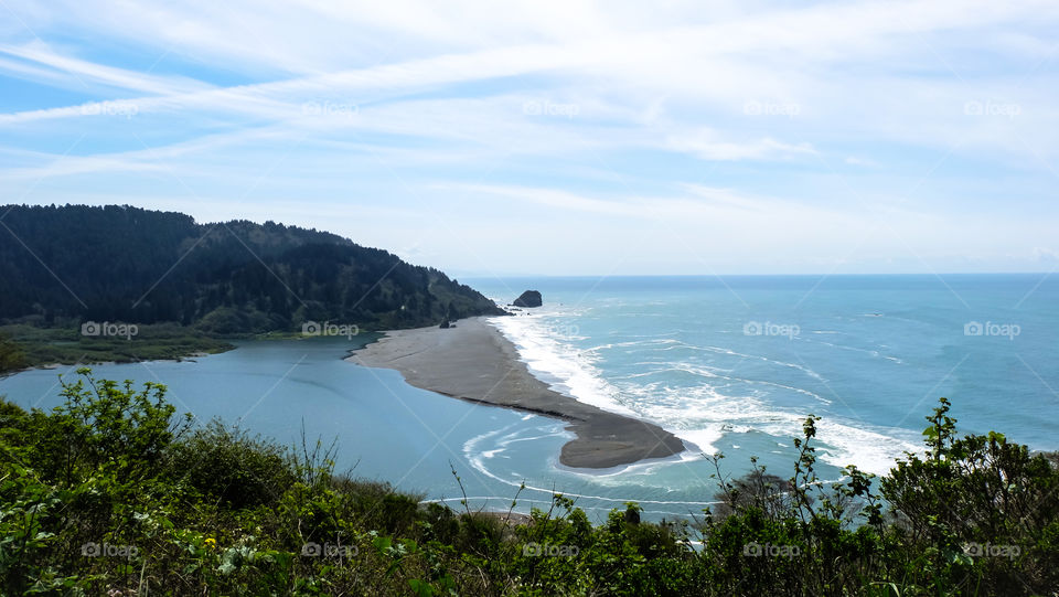 Beautiful island against cloudy sky