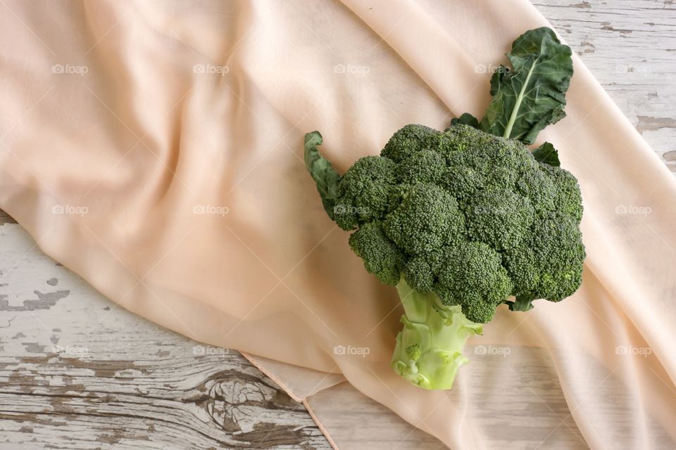 fresh and healthy broccoli on a beige cloth