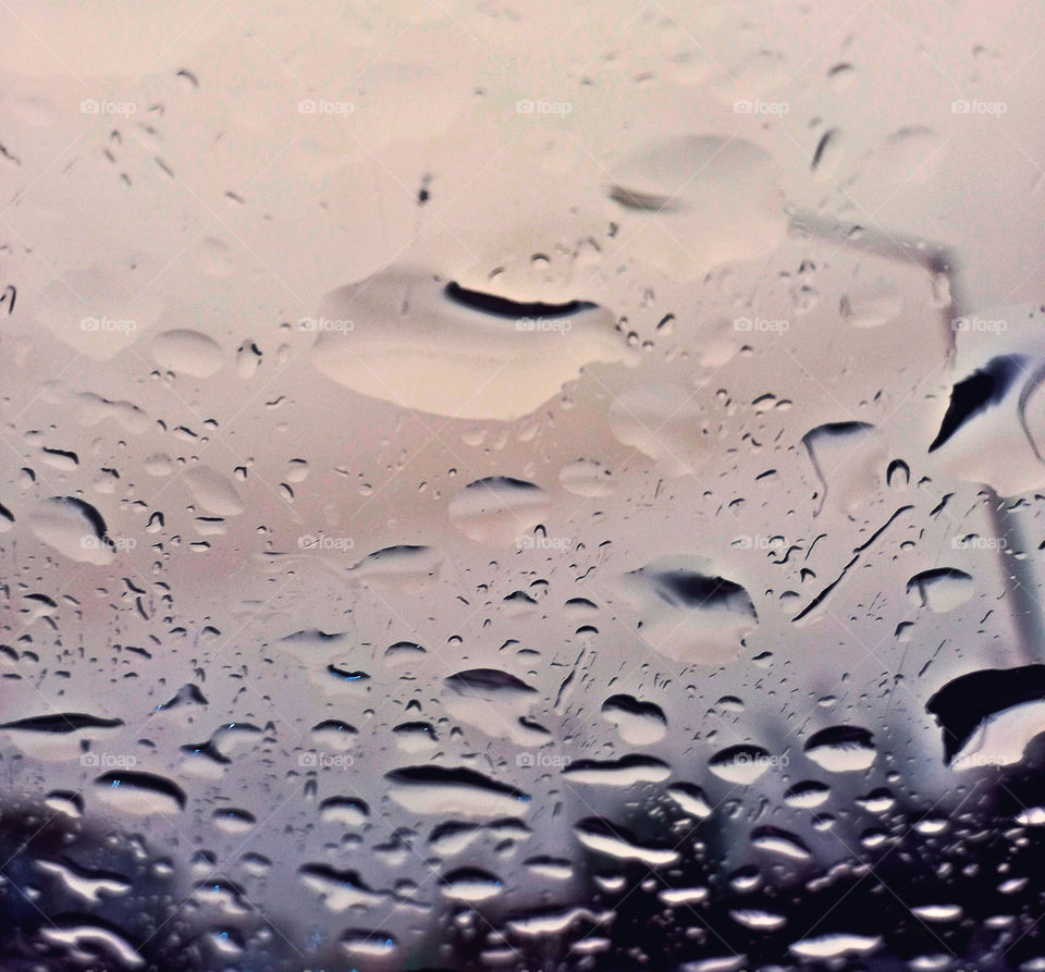 perfect rain drops on the glass of the car