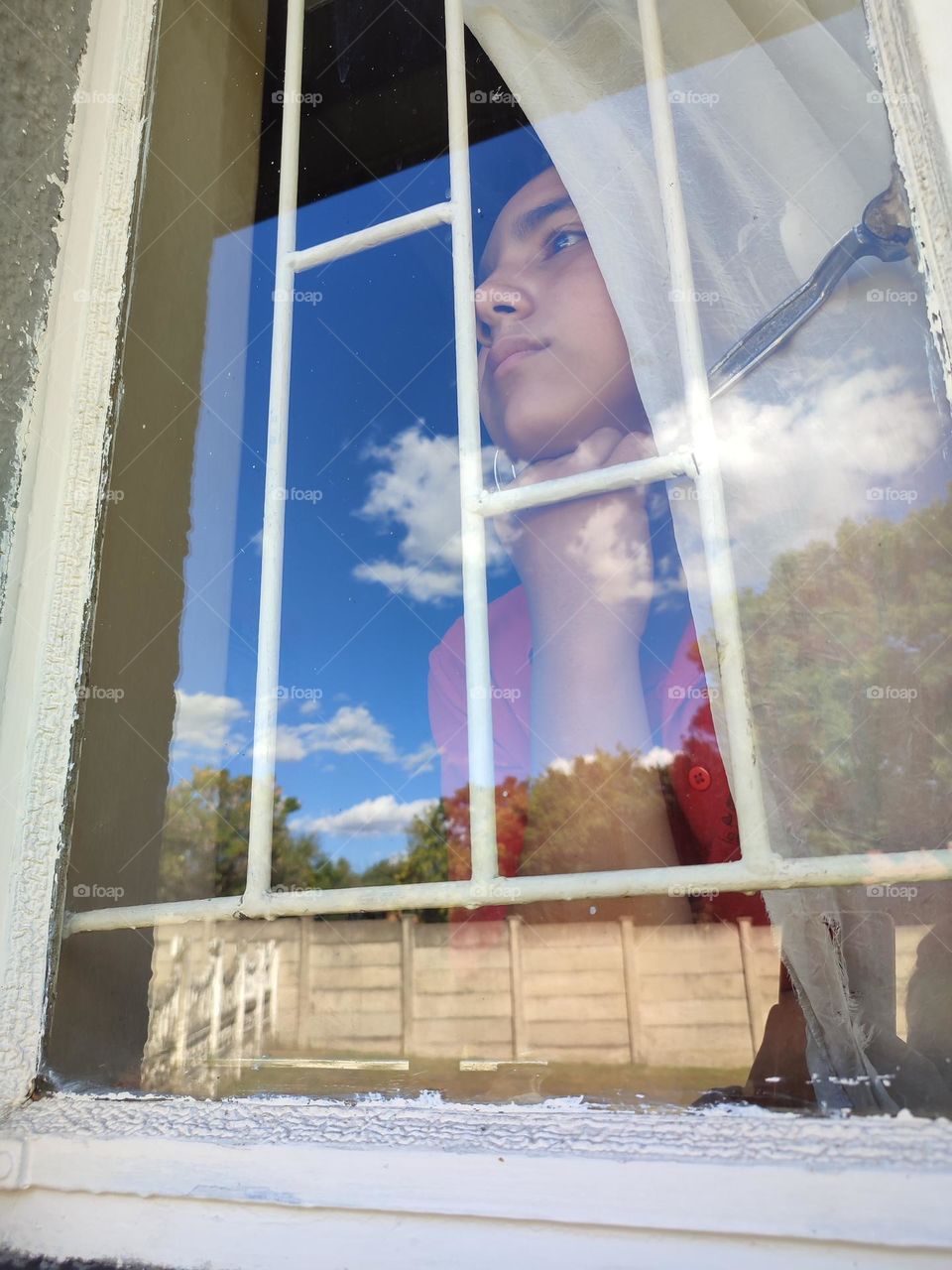 Young male looking out of the window
