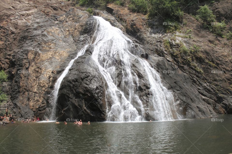 goa dudhsagar fall waterfalls meaning milk flows people cool off the hot summer heat well maintained famous hundred's of tourists daily n a must see place