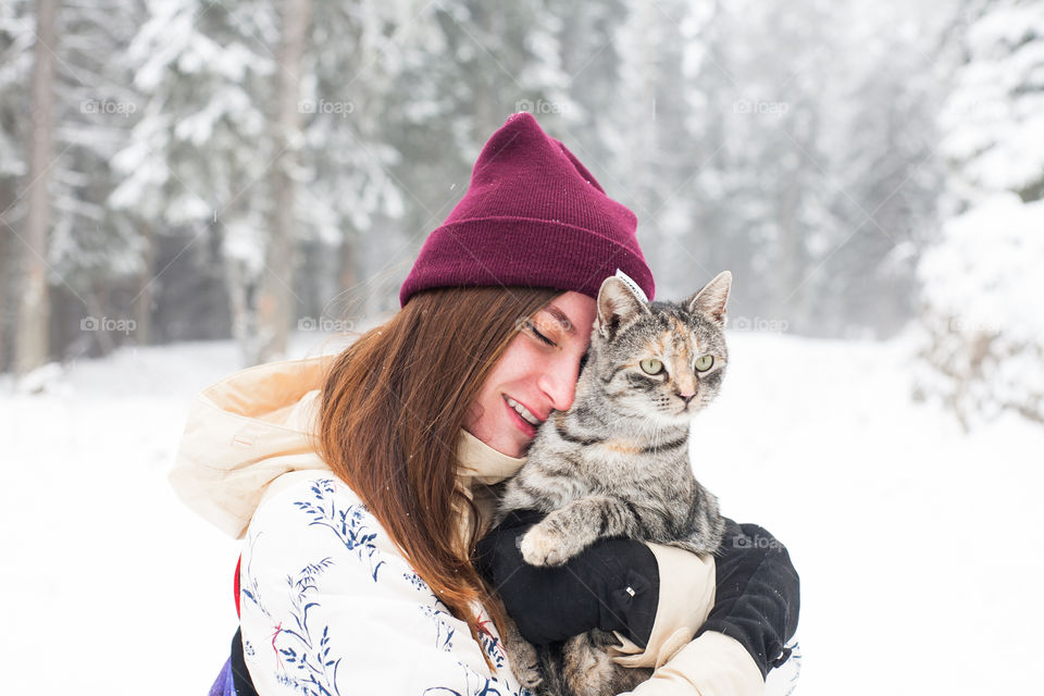 woman smiling while holding a cat
