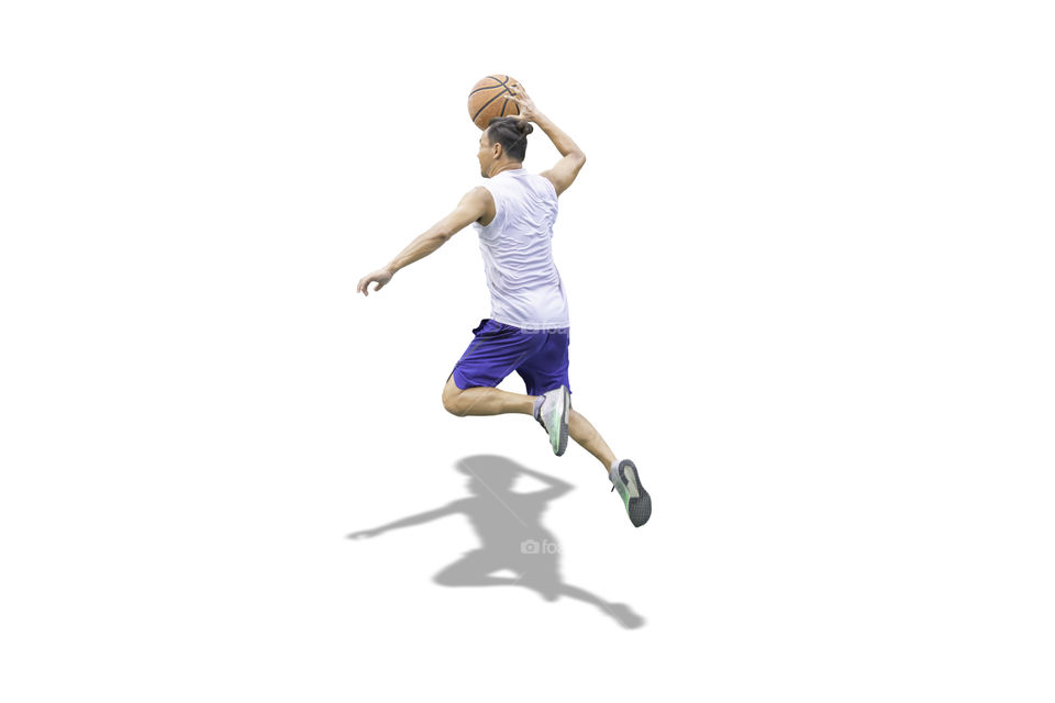 Isolated Basketball in hand man jumping on a white background with clipping path...