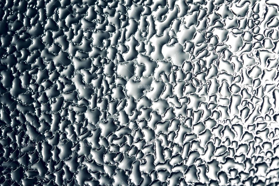 wet window glass with splashes and drops of water.