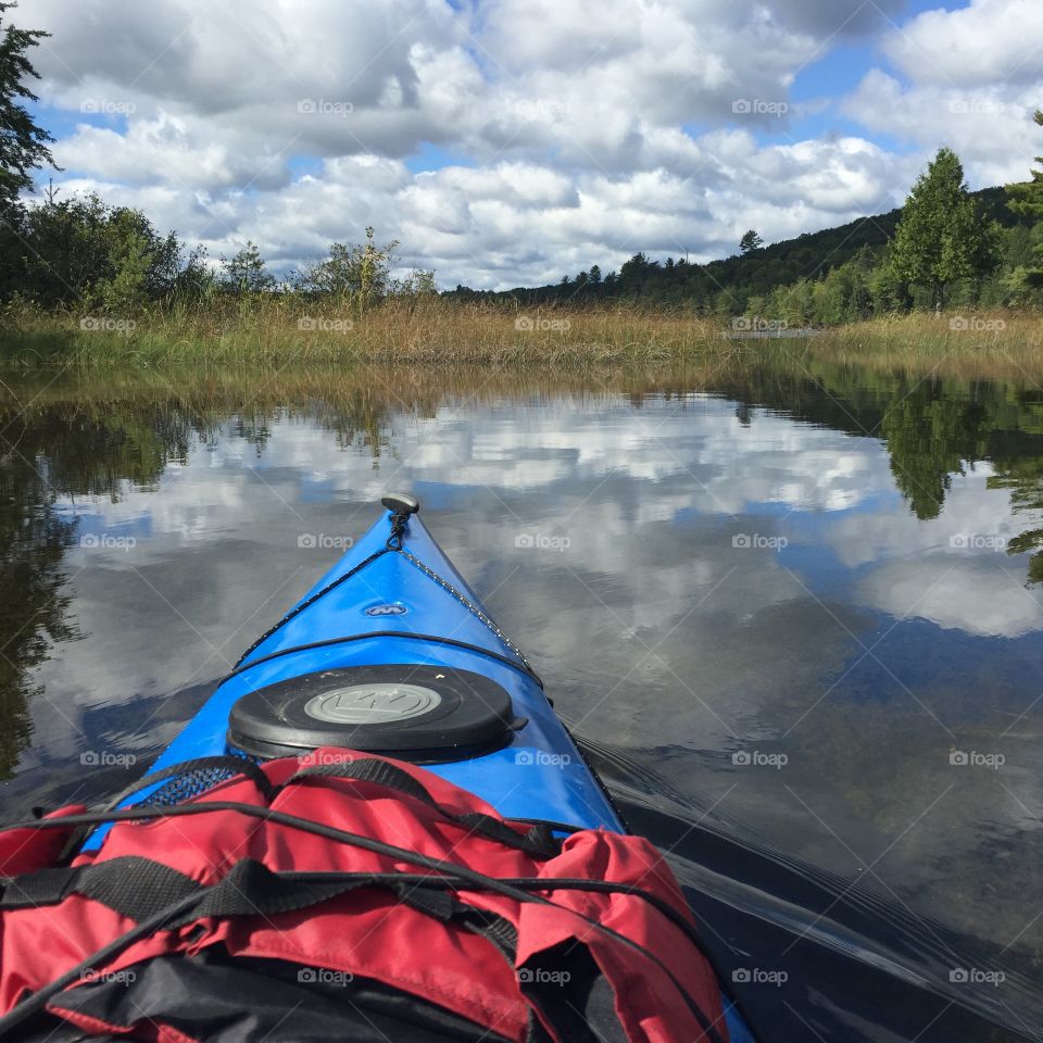 Front of kayak on lake in MI. Front of kayak while paddling through the fortune chain of lakes in the upper Peninsula of Michigan