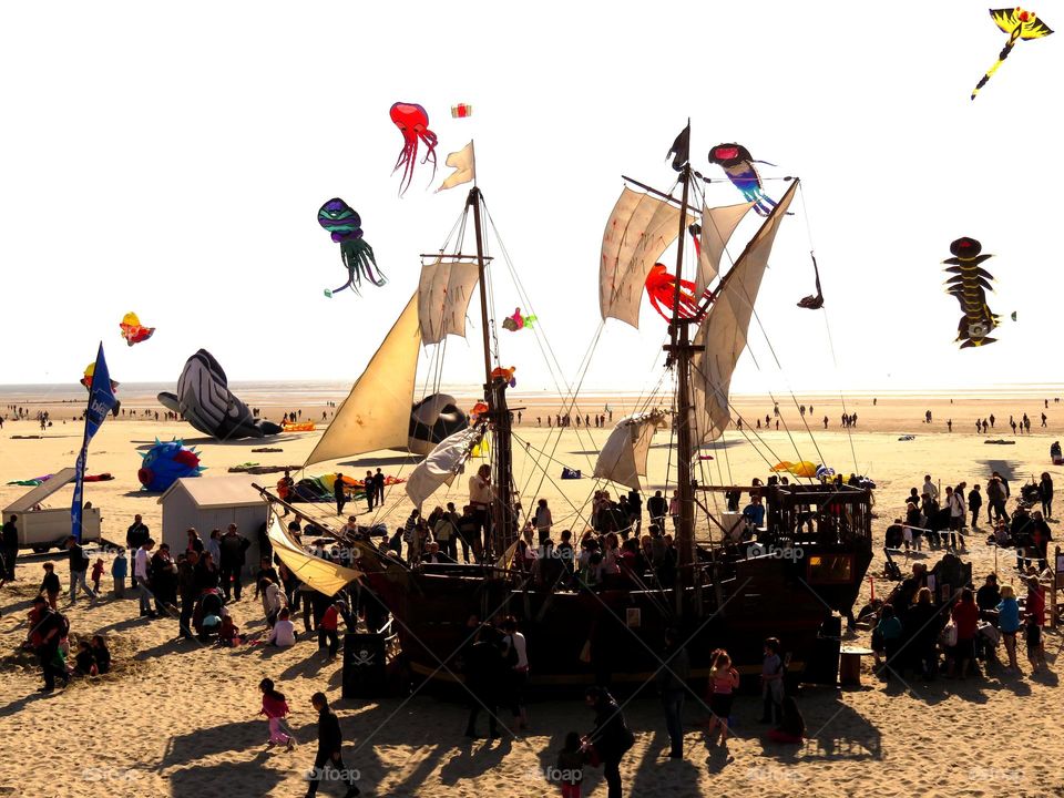 pirate's boat on the beach and kites . At the International kite competition in Berck France 