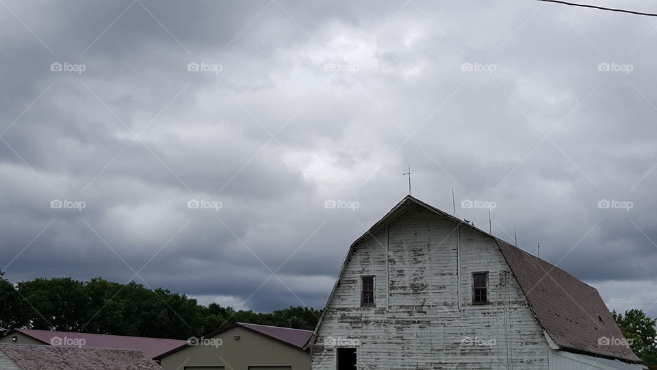 cloudy weather over the top of a barn