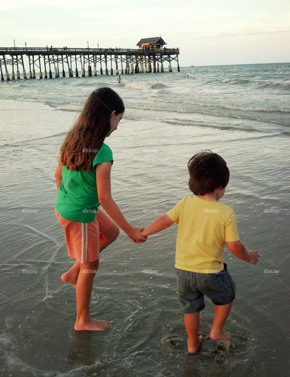 Children on beach at Cocoa Beach pier in Cocoa Beach Florida