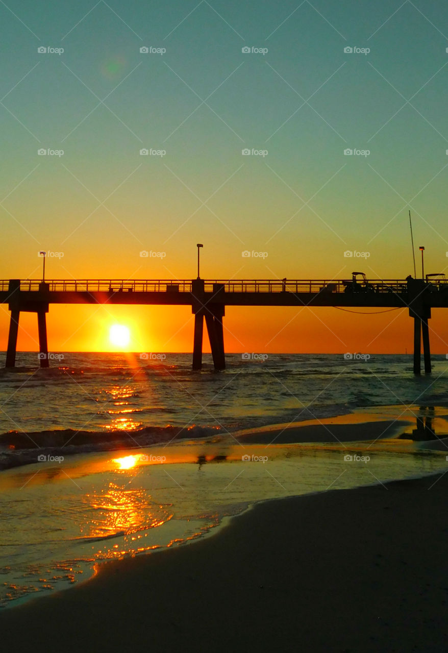 Silhouette of pier over sea at dusk, Florida