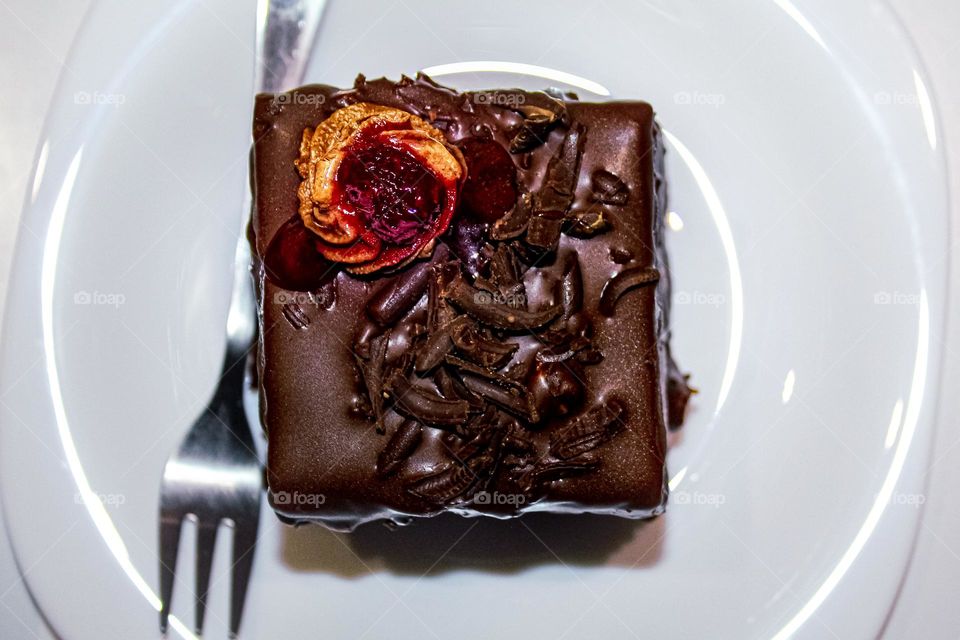 Pieces of chocolate cake with raspberries