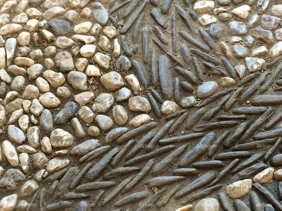 Ancient sidewalk rock pattern in Granada, Spain