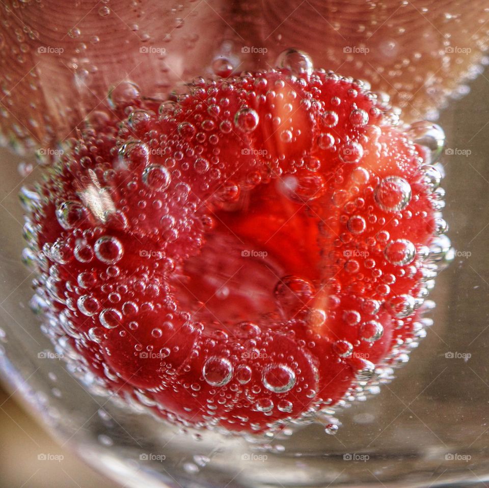 Holding down a raspberry in fizzy water with one hand and shooting this snap with the other 