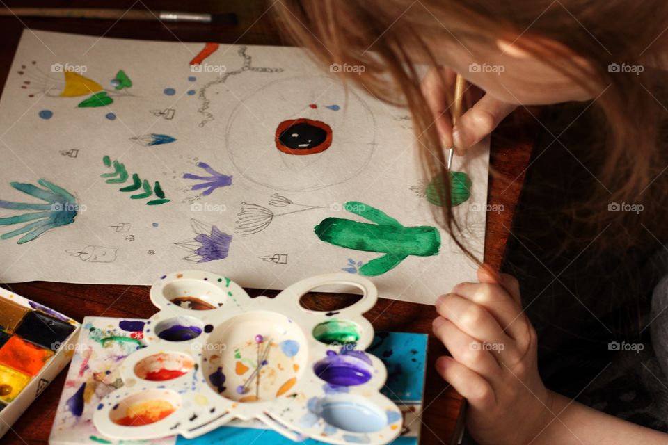 Young artist writing surrealistic painting