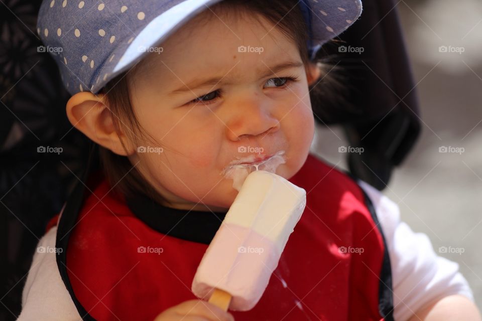Cute boy eating popsicle stick ice cream