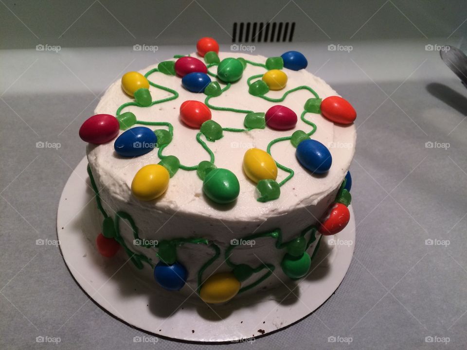 Christmas lights cake! Almond M&M's for the light bulbs, green Mike n Ike's for the light base and frosting for the wire. 