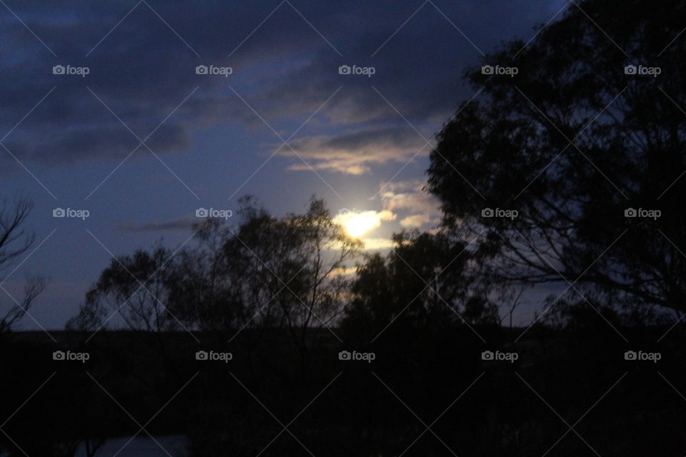 Cloudy moonlit night on the river