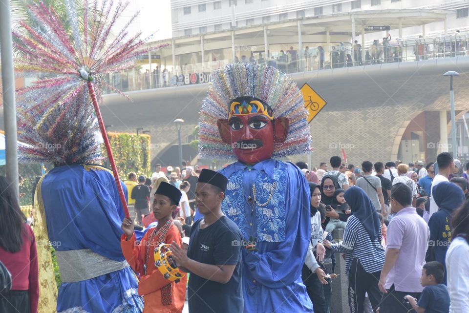 Betawi traditional dolls and Betawi ondel ondel dance in the streets on Car Free Day in Jakarta.  Sunday 11 June 2023