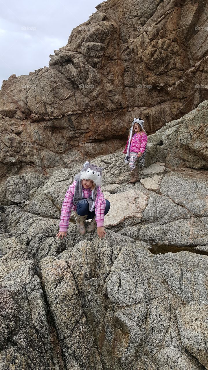 Close-up of happy two girls on rock