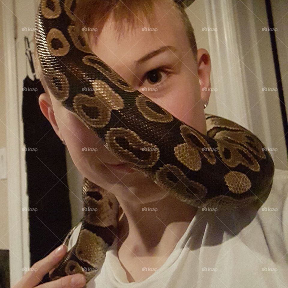 boy with snake wrapped around head