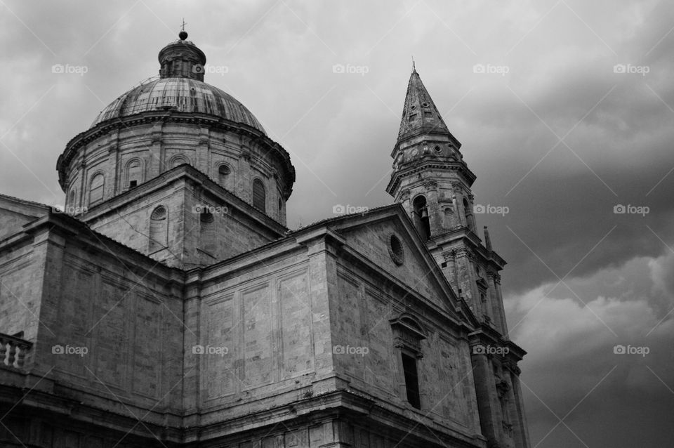 Beautiful Italian church over clouded grey sky 
