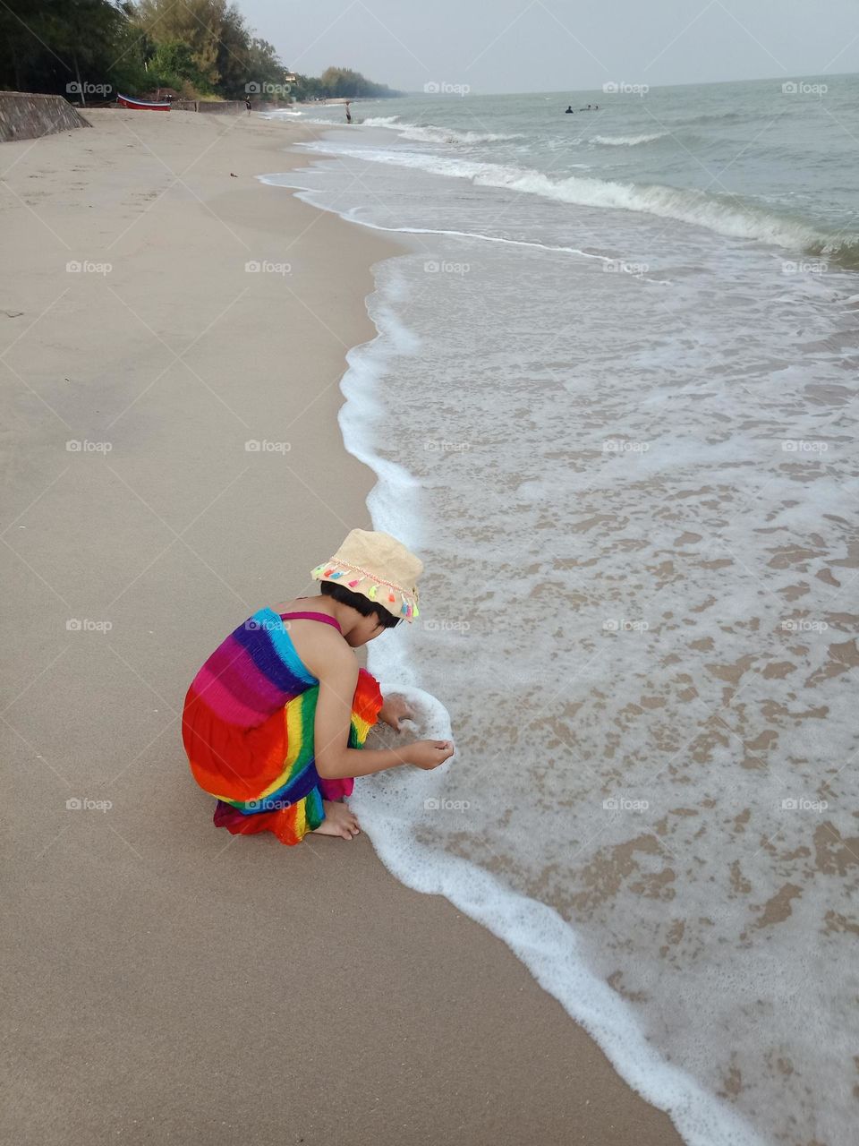 Wave hit the playing kid