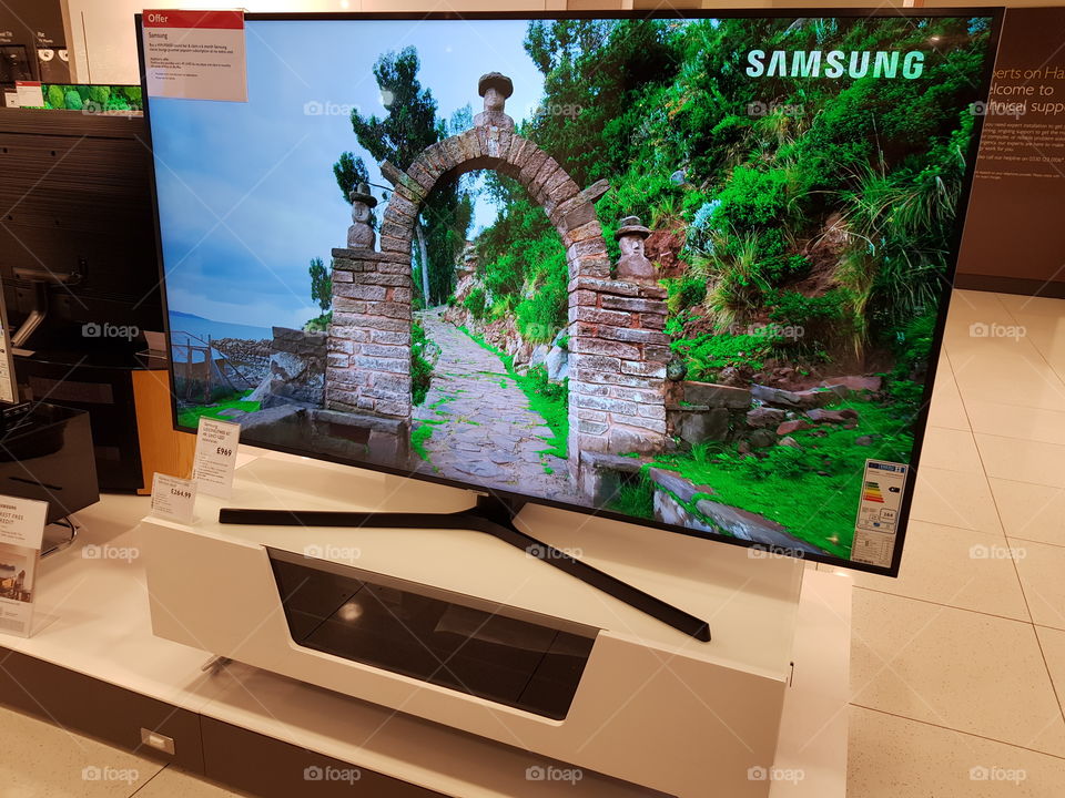 Samsung UE65NU7400 4K UHD television on white TV stand at Peter Jones Sloane square Chelsea King's road London