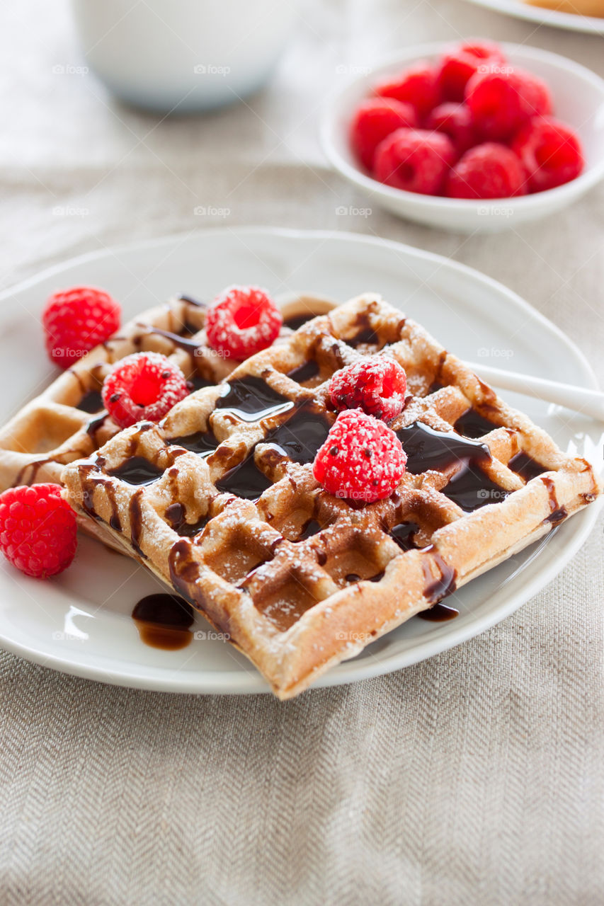 Breakfast with waffle, sirup and berries