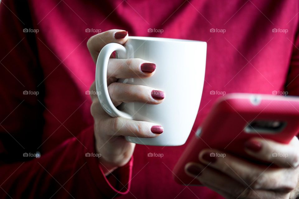 Woman's hands with beautiful simple burgundy  manicure