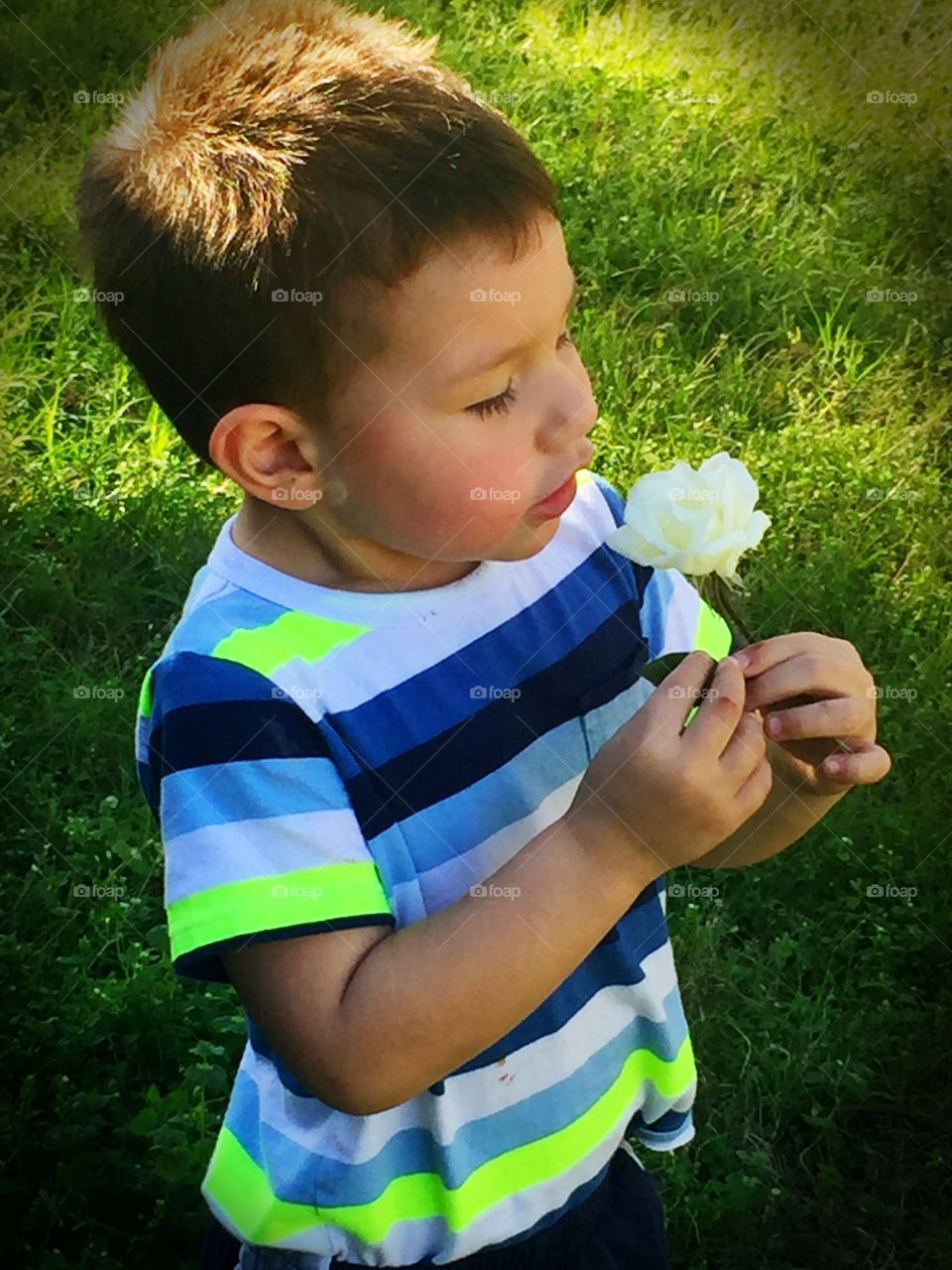 Close-up of small child with flower