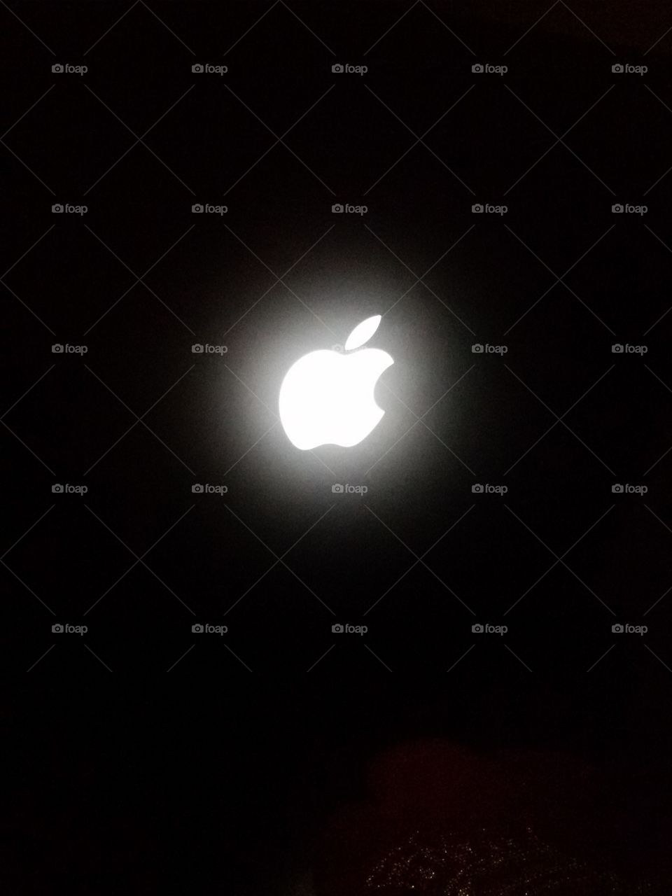 Apple sign on a laptop in dark