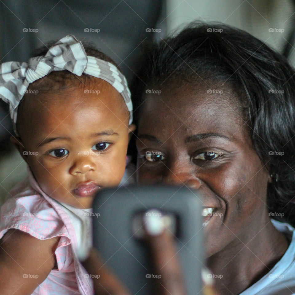 Woman taking a selfie with infant